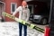 The image shows Eric Frenzel with his skis in front of his house. 