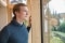 The image shows Benedikt Doll looking out the window
