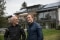 The image shows Benedikt Doll with father Charly in front of the house