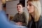 The image shows an employee in a meeting.