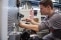 The image shows an apprentice at work.