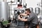 The image shows a heating installer installing a heating system. 
