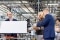 The image shows Olaf Scholz at the heat pump production.