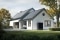 The image shows the exterior of a house with solar panels on the roof, a heat pump in the garden and a charging station in the garage.