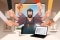 The image shows a figure sitting at a desk and shaking many hands.