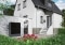 The image shows a Viessmann heat pump in front of an old building as a symbol of the cooperation between Viessmann Climate Solutions and badenova