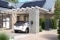The image shows an electric car at a Viessmann charging station under a carport next to a house and a Viessmann heat pump, serving as a symbolic representation of the partnership between Viessmann Climate Solutions and LichtBlick.