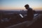 The picture shows a man with a laptop over the roofs
