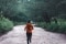 The image shows a jogger in the forest