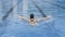 The image shows a female swimmer in a swimming pool